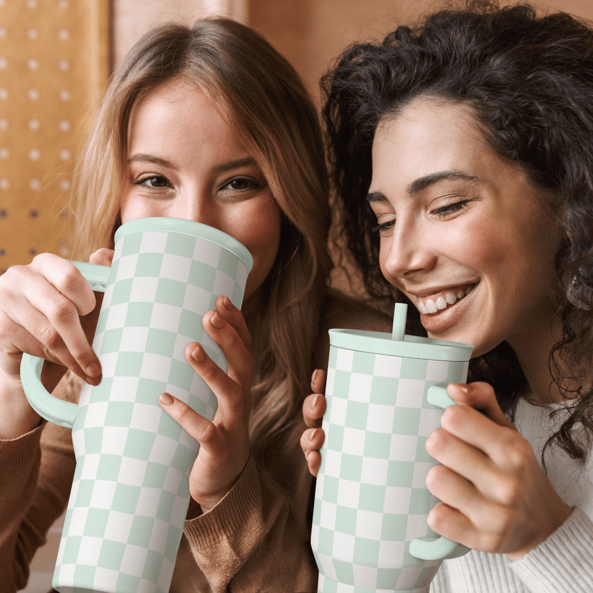 Mint checkered 40oz tumbler with straw, held by two people drinking