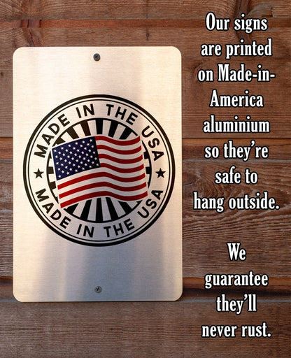 Made-in-America aluminum metal sign with circular U.S. flag badge and guarantee text.