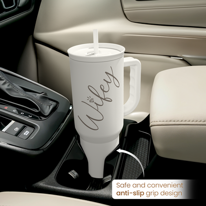 White tumbler with handle and straw, anti-slip grip design shown in car console